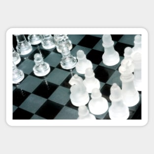 The next move - Glass chess pieces on a chess board Sticker